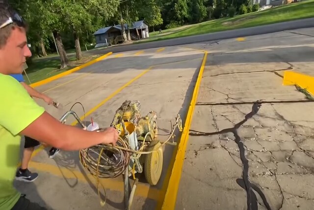 Montgomery Asphalt Paving worker doing striping on a spacious parking lot